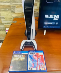 PlayStation 5 with one controller and 2 games